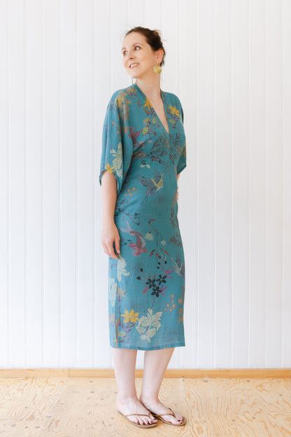 Side view of a woman wearing a vintage inspired summer dress with kimono sleeves.