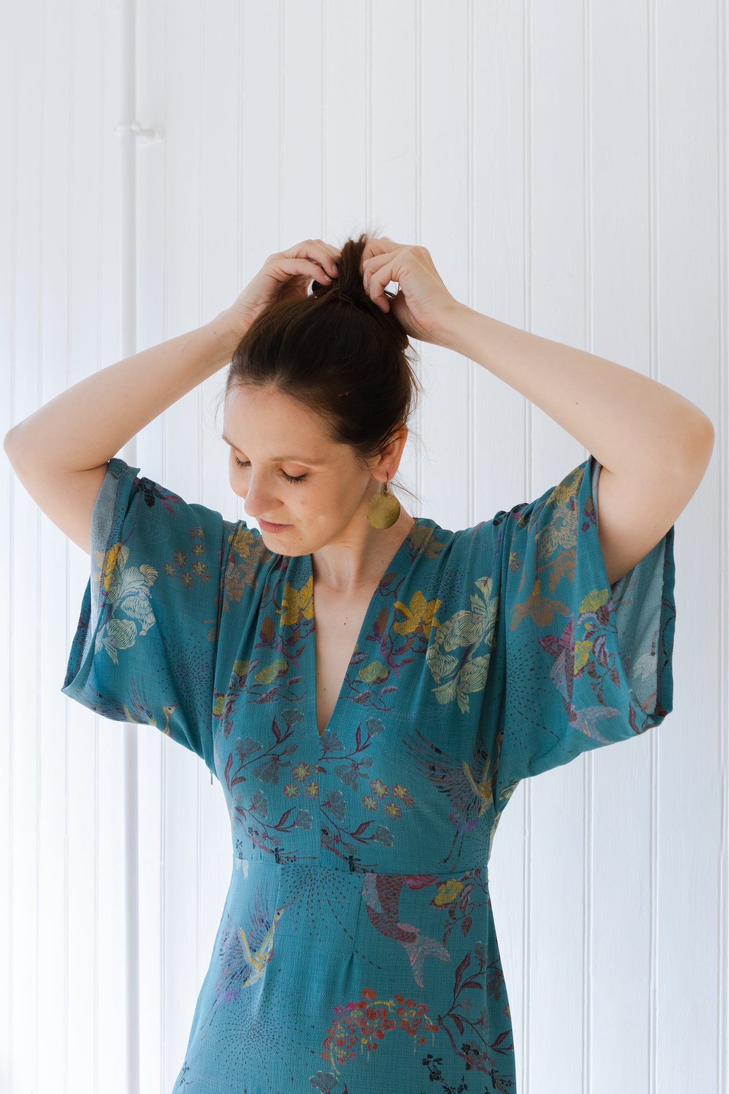Close up of kimono sleeves on teal coloured, vintage inspired summer dress.