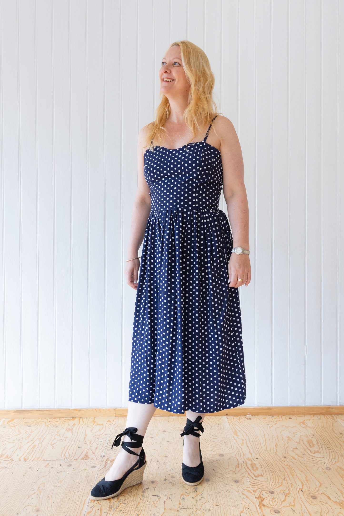 Blue and white polka dot vintage inspired midi length dress with fitted bodice, gathered skirt and rouleau straps.