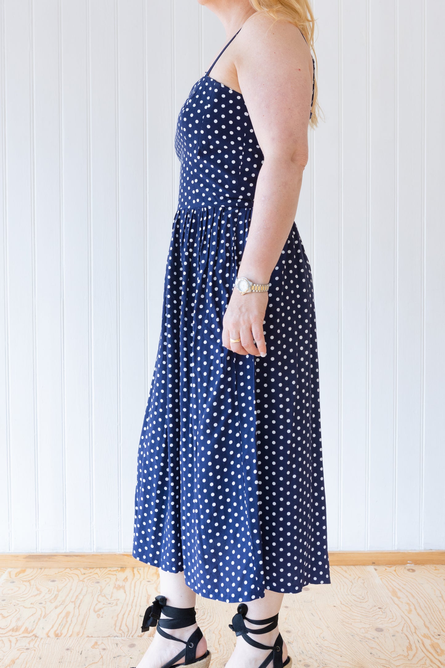 Side view of vintage inspired blue and white polka dot summer dress.