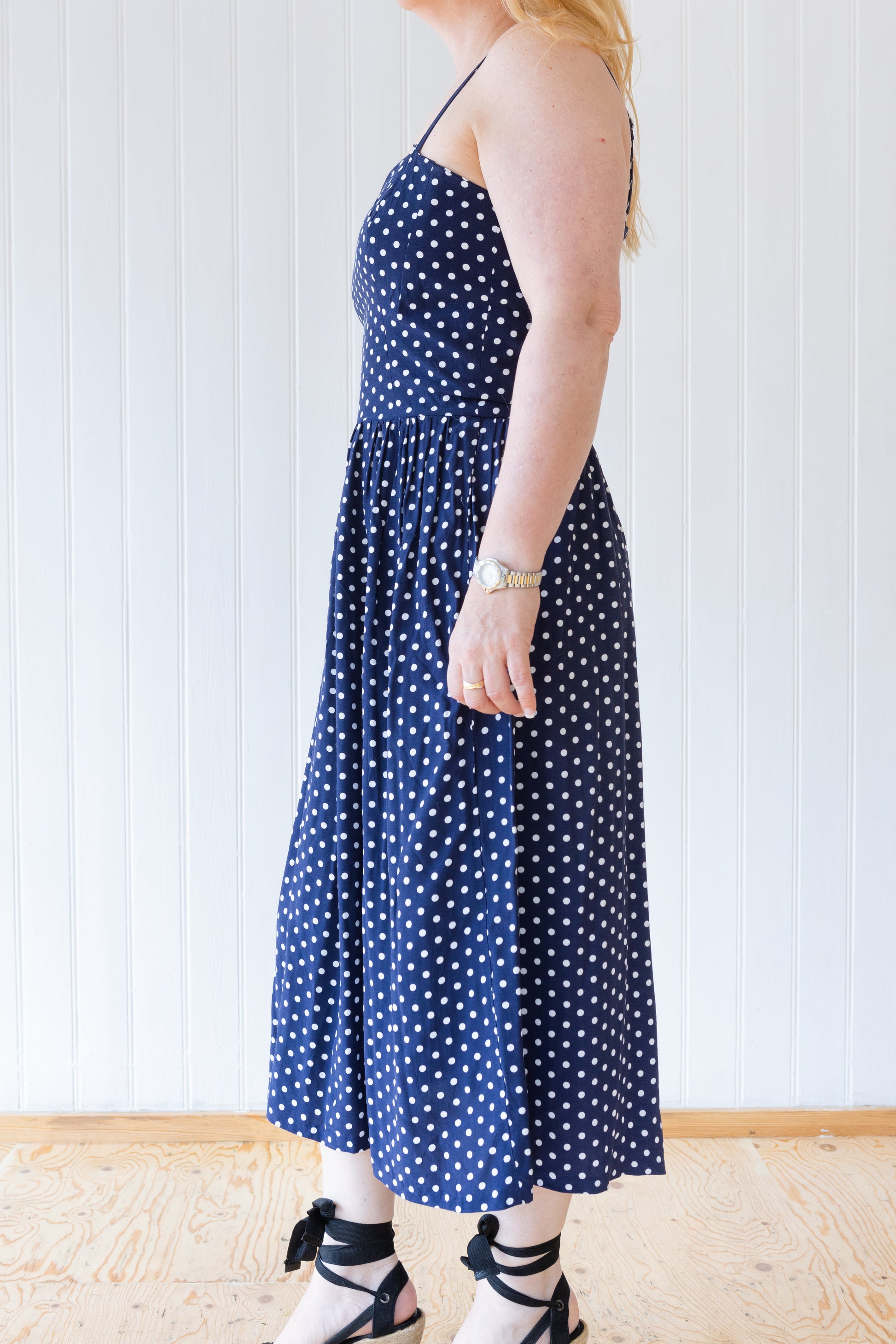 Side view of vintage inspired blue and white polka dot summer dress.