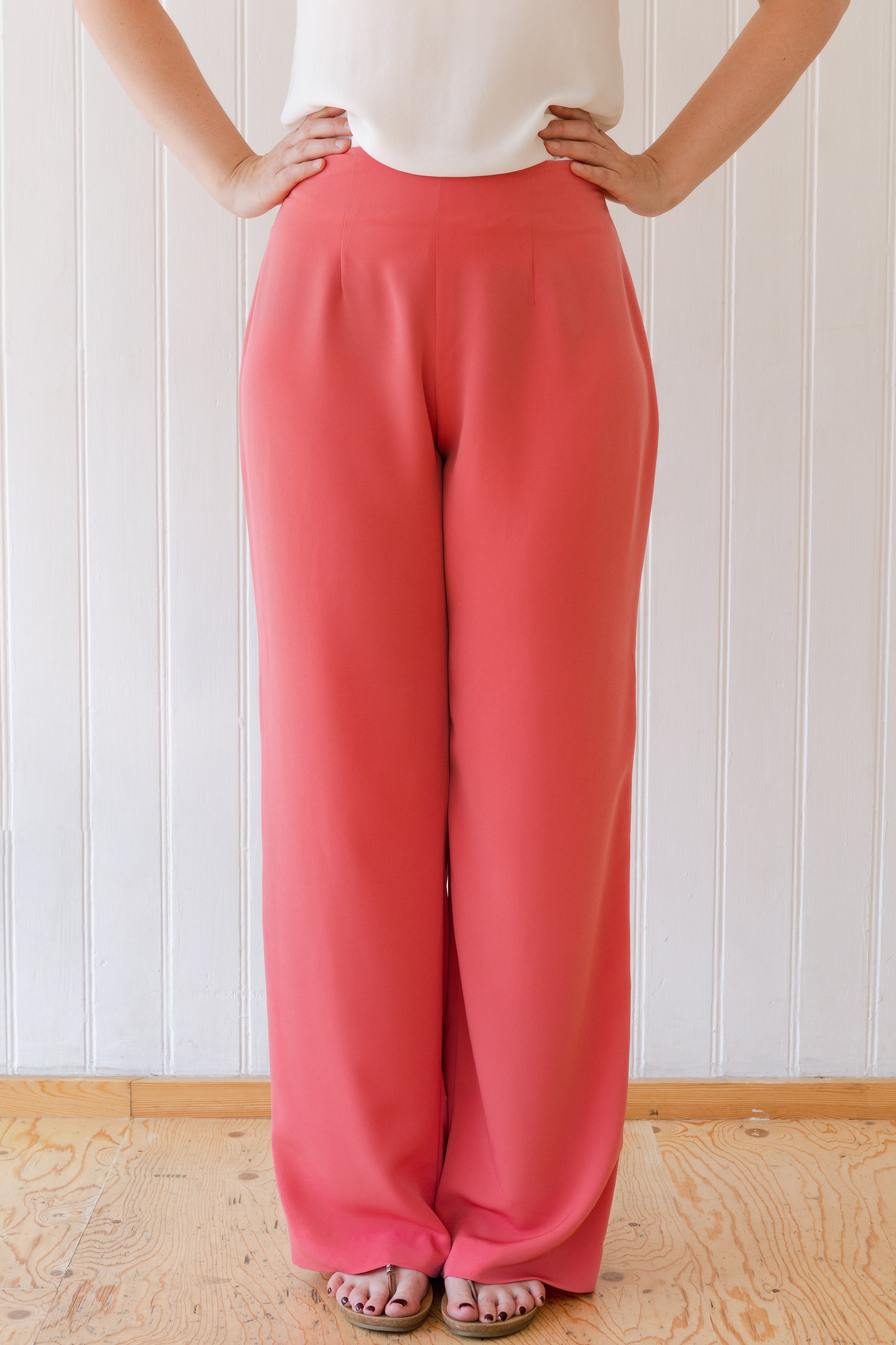 Wide leg vintage inspired trousers fitted at the waist in a soft coral colour.