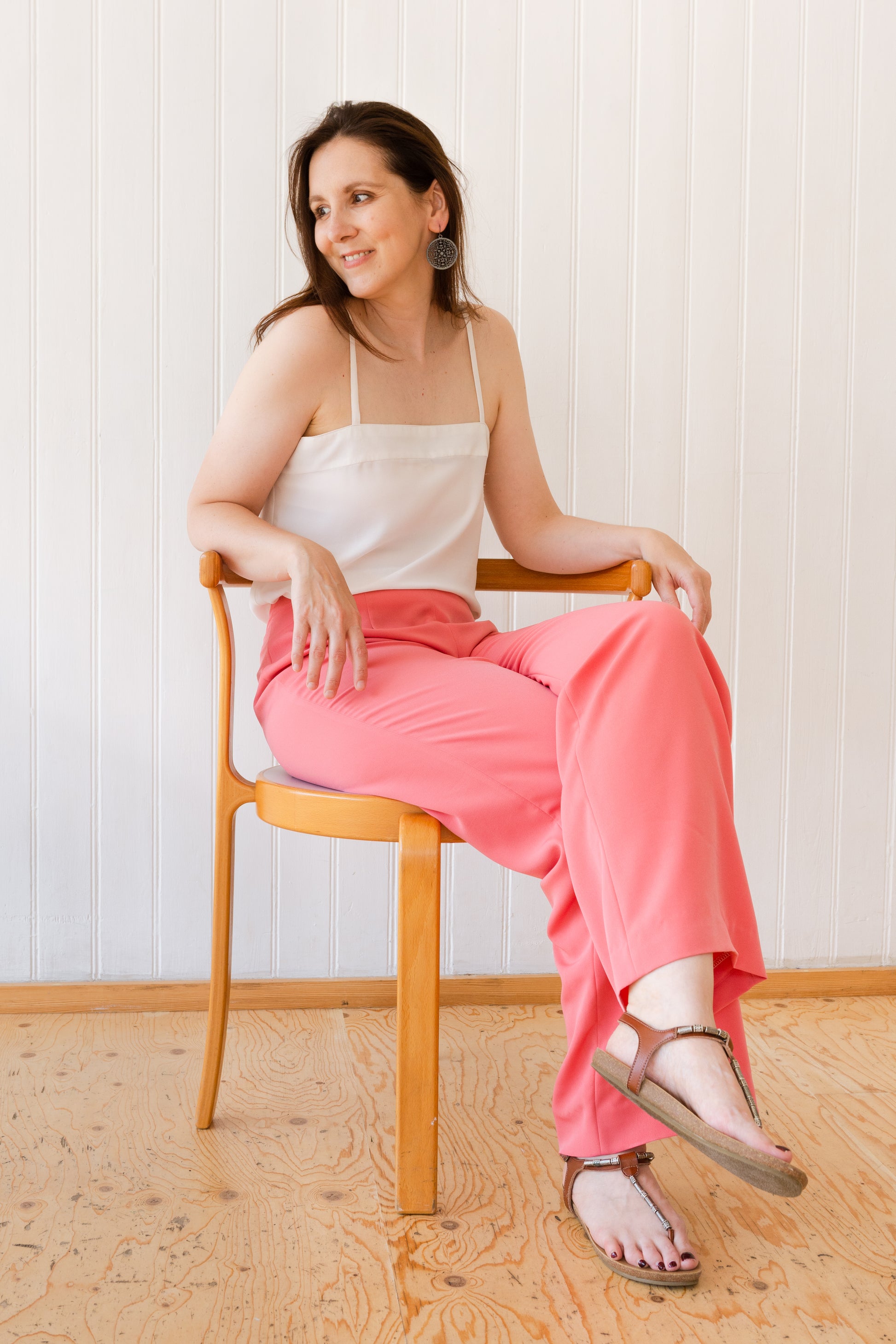 Woman sitting down in a pair of wide leg vintage inspired trousers.