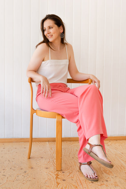 Woman sitting down in a pair of wide leg vintage inspired trousers.